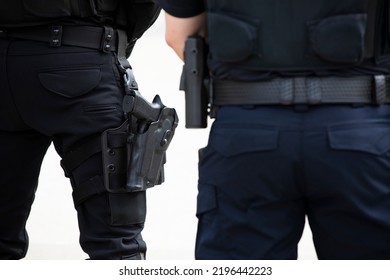 Daytime View Of A White Police Officer's Utility Belt And Gun Holster.