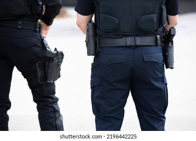 Daytime View Of A White Police Officer's Utility Belt And Gun Holster.