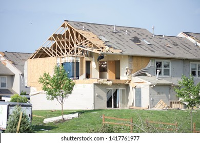 Dayton, OH- May 27, 2019: Memorial Day Storm Damage in Beavercreek (Dayton) Ohio. Damage Includes ripped off roofs, attics opened, cars destroyed, garages split, walls broken, house interiors visible
