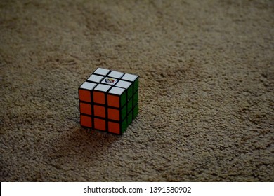 Dayton, OH- May 7, 2019: Solved Rubix Cube Isolated Sitting On A Tan Carpeted Floor