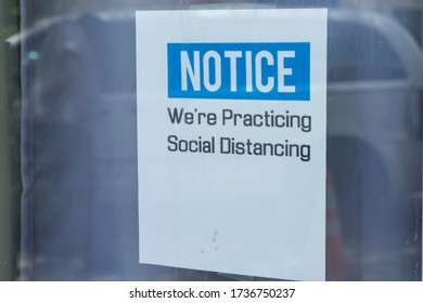 Dayton, OH, USA, 2020-05-09: Social Distancing Sign On Store Window