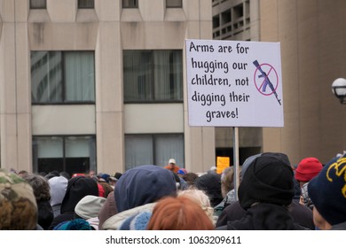 DAYTON, OHIO - MARCH 24: 'Arms are for hugging our children, not digging their graves!' sign at March for Our Lives gathering in downtown Dayton, Ohio on March 24, 2018.