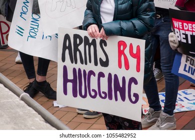 DAYTON, OHIO - MARCH 24: Person holding sign that reads 'Arms R4 Hugging' at March for Our Lives gathering in downtown Dayton, Ohio on March 24, 2018.