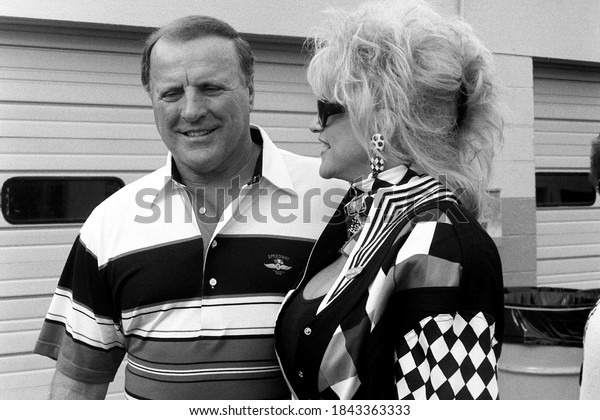 Daytona Beach, FL / USA - February 11, 1992: A\
vintage, old-school black-and-white portrait of legendary race\
driver A.J. Foyt and Ms. Hurst, Linda Vaughn, at Daytona\
International Speedway.
