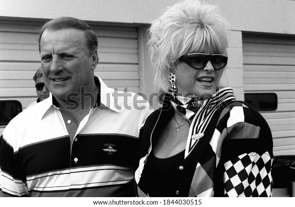 Daytona Beach, FL / USA - February 11, 1992: A\
vintage, black-and-white photo of legendary race car driver A.J.\
Foyt and Ms. Hurst, Linda Vaughn, at Daytona International Speedway\
in Florida.