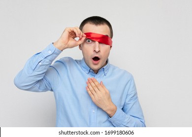 Dazed Man Removes Red Blindfold, Portrait, White Background