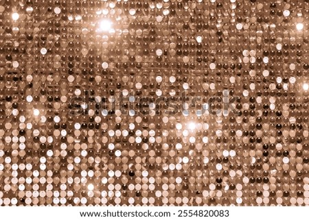 A dazzling array of sequins reflecting light in warm brown tones, perfect for festive projects. Demonstrating color of 2025 year.
