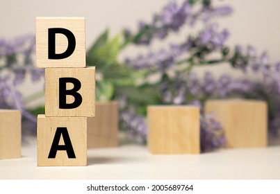 DBA acronym from wooden blocks with letters, DataBase Administrator or doing business as abbreviation DBA concept