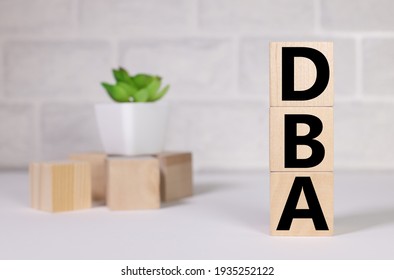 DBA. Doctor of Business Administration. text on wood cubes. text in black letters on wood blocks
