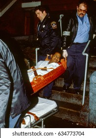 DC Paramedics Carry A Shooting Victim Out From His Apartment To A Waiting Ambulance For Transport To The Nearest Hospital To Treat His Minor Gunshot Wound Washington DC., 1989.