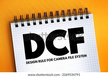 DCF - Design rule for Camera File system acronym text on notepad, abbreviation concept background