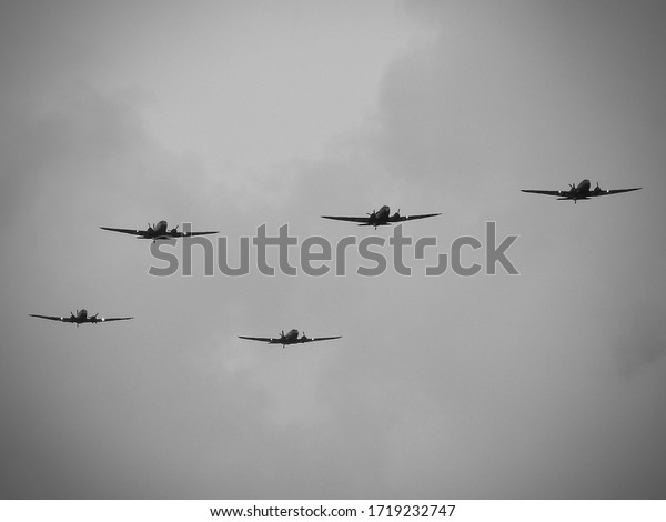 D-Day celebrations with parachutists and Dakotas\
above Europe, France, Belgium and the Netherlands. Anniversary of\
the battle of Normandy. (DDay, D\'Day, D Day, D’Day, World War II or\
Second World War)