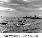 D-Day landing craft head for Omaha beach during the Normandy invasion on June 6, 1944. in right background is the cruiser USS Augusta, flagship of the Western Naval Task Force.