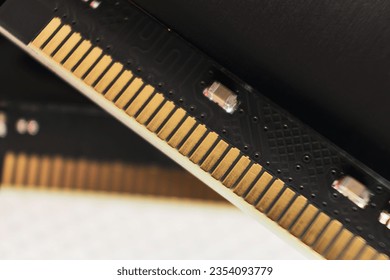 DDR4 DRAM memory module golden electrical contact macro. Computer RAM chipset close-up. Desktop PC memory hardware components