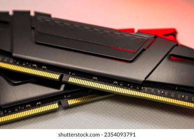 DDR4 DRAM memory modules in red light. Computer RAM chip close-up on white. Desktop PC memory parts