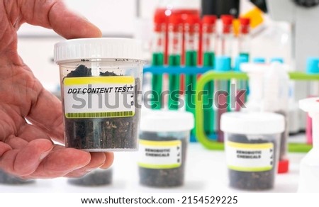 Ddt. Ddt content in soil sample in plastic container. Study of agricultural soil in a chemical laboratory