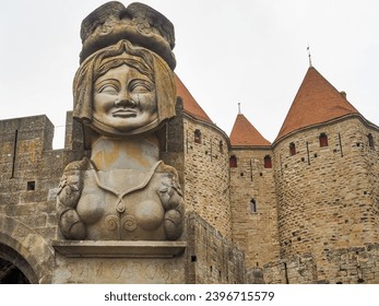 Cité de Carcassonne is a medieval fortified city in Occitania, France. Part of double walls with towers and huge statue of Lady Carcas welcomes tourists at the main entrance to the city of Carcassonne