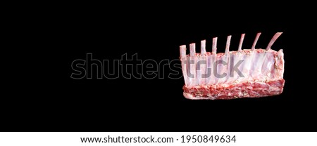 Carré de Cordeiro. Raw rack of lamb. Spiced with rosemary and herbs on black background [[stock_photo]] © 