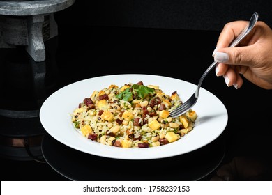 
Baião De Dois, A Dish Of Brazilian Northeastern Cuisine, A Female Hand Holds A Fork With The Food