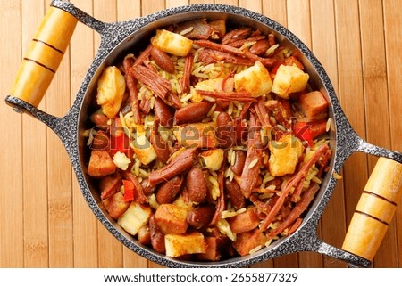 Baião de Dois in a rustic pot, a typical dish of Brazilian northeastern cuisine with rice, beans, jerked beef and curd cheese. Top view