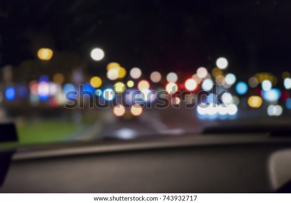 De focus of\
inside the car with bokeh from traffic lights at the night in city\
road, Blurred defocus night\
life