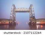 De Hef disused railway bridge across the Koningshaven in Rotterdam in blue hour during misty morning