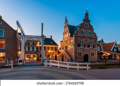 De Rijp, Netherlands - June 23, 2020: Town Hall in De Rijp, Alkmaar, North Holland, Netherlands, captured at dusk. It was built in 1630 and is now in use as a tourist office and wedding venue.
