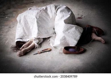 Dead body of asian woman suicide by slit her wrist, one bare foot was cover by white sack, abadoned on concrete floor at home. Violence, suicide,  depressed concept.