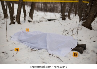 Dead Body In Snow. Markers And Tape Around The Body. 