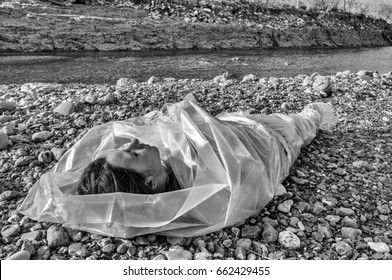 Dead Body Wrapped In Plastic Near A River