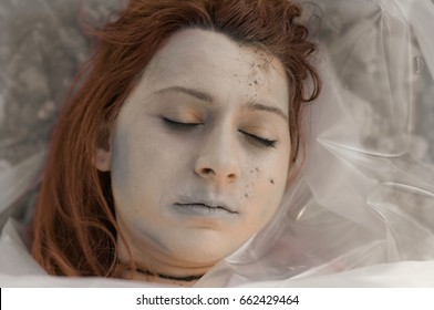 Dead Body Wrapped In Plastic Near A River