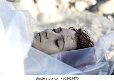 Dead Body Wrapped In Plastic Near A River