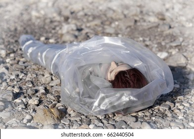 Dead Body Wrapped In Plastic Near A River