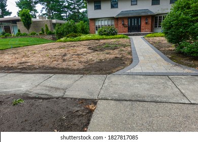 Dead Brown Lawn In Front Of A Large House With A Long Sidewalk