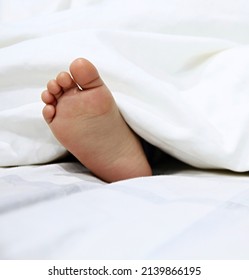dead corpse feet sticking out of bed covers stock photo  - Shutterstock ID 2139866195