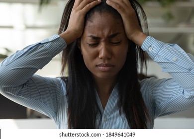 Dead end. Portrait of depressed perplexed young mixed race lady freelancer office employee standing with closed eyes hugging head with hands missing deadline, losing work results, failing colleagues - Shutterstock ID 1849641049