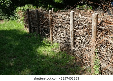 The dead hedge is located in the vicinity of the Wuhle River in the recreation area of Berliners. A dead hedge is a barrier constructed from cut branches, saplings, and foliage. Berlin, Germany
