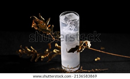 Dead leaves and a transparent drink