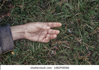 A Dead Man's Hand In The Grass. Murder. Kriminal. Victim