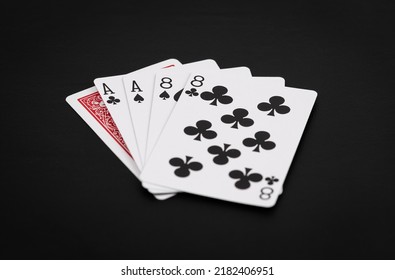 Dead man's poker hand showing aces and eights on a black background