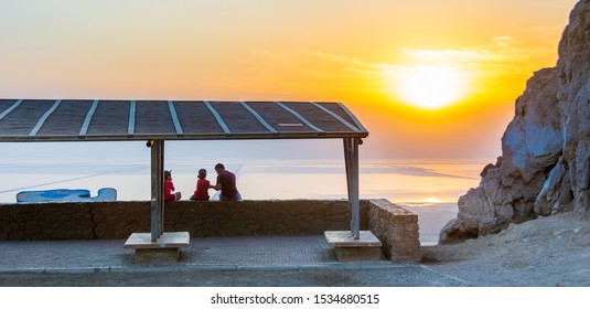 DEAD SEA, ISRAEL - OCT. 14, 2019: A Family Of Father And Two Boys Admiring A Beautiful Sunrise On The Dead Sea In The South Of Israel From The Dead Sea Lookout. 