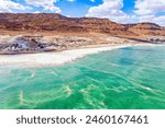 The Dead Sea. Resort for relaxation and treatment. Israel. Cloud shadows reflected in the water. The evaporated salt is collected on the water. Drone filming. 