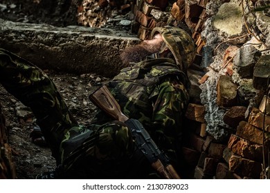 Dead Soldier. Dead Soldier Killed Russian Soldiers. Military Company Mercenary, Brutal Soldier In Battle In Uniform And Plate Carrier Holding Service Rifle, Ready To War.