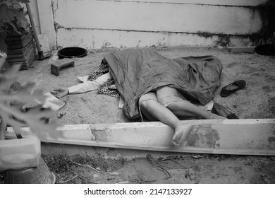 Dead woman lay down under bag covered death body from accident or murder at house of victim with evidence. Horror scene for Halloween. Killed woman on ground. - Shutterstock ID 2147133927