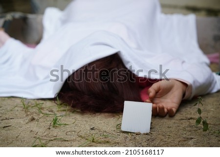 Dead woman lay down under bag covered death body from accident or murder at house of victim with evidence. Horror scene for Halloween. Rape and murder case scene. 