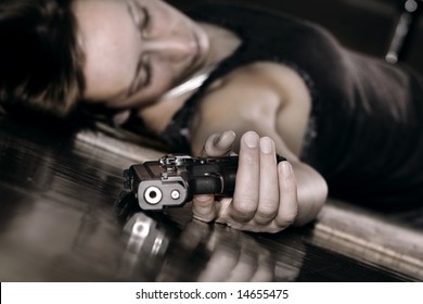 dead woman lying on the floor, gun in the hand