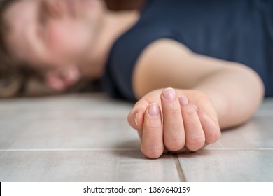 Dead woman lying on the white floor - suicide concept
