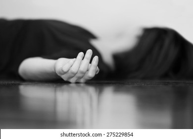 Dead Woman's Body Lying On The Floor Focus On Hand