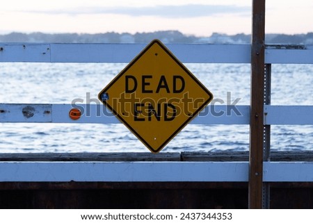 Deadend caution sign roadblock at the end of a pier 