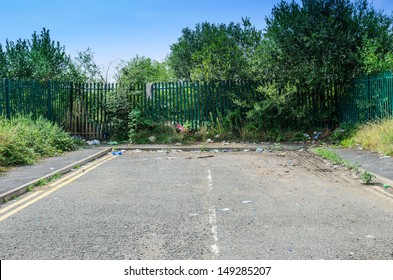 A dead-end road, disused and covered in rubbish/overgrown, England, UK